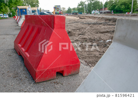 Plastic barriers on the construction site. Water and sewerage reconstruction and road construction Plastic barriers on the construction site. Water and sewerage reconstruction and road construction 81596421