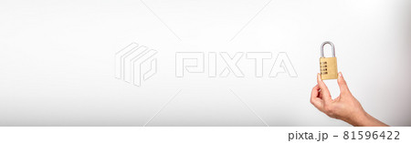 Padlock with a code in a woman's hand on a long horizontal banner 81596422