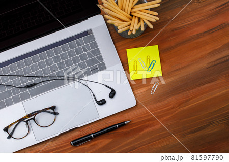Top view shot of laptop notebook computer with earphone and cactus pot on wood background with copy space 81597790