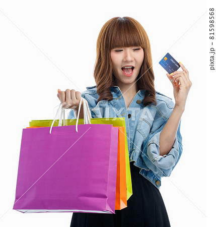 Woman holds credit card and shopping bags. Woman holds credit card and shopping bags. 81598568