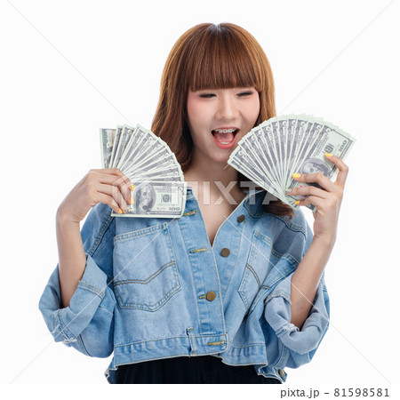 Asian woman smiles and holding American banknotes.. Asian woman smiles and holding American banknotes.. 81598581