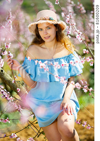 Girl in the spring garden peach in blue dress and hat Girl in the spring garden peach in blue dress and hat 81600209