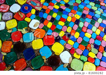 Top view on pieces of multicolored ceramic tiles decorated in garden. Old pavement of tiles textured. Street mosaic cobblestone sidewalk. Abstract,background and pattern of ceramic tile on the floor. Top view on pieces of multicolored ceramic tiles decorated in garden. Old pavement of tiles textured. Street mosaic cobblestone sidewalk. Abstract,background and pattern of ceramic tile on the floor. 81600282