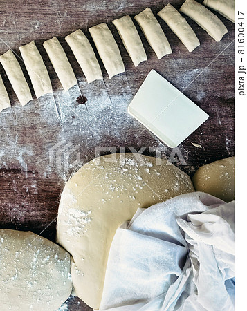 Wheat flour for making dough sticks or fried patongo on wooden board. Picture of one of the steps in making Patongo snacks. Patongo is a deep-fried dough stick. Popular breakfast for Thai people. 81600417