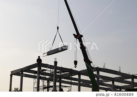 precast concrete beam intralled at construction site by mobile crane 81600889