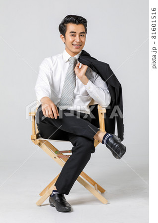Business man is sitting on studio chair. 81601516