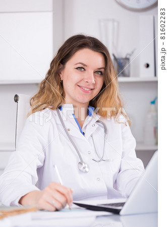 Nurse in uniform filling up documents 81602283