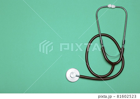Medical background. Stethoscope on a clear green background. Pharmacology, clinic, health and disease treatment concept Medical background. Stethoscope on a clear green background. Pharmacology, clinic, health and disease treatment concept 81602523