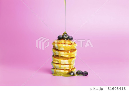 Pancakes with berries on a pink banner background. Lush delicious pancakes with blueberries and syrup for brunch on a minimal colored background. Beautiful bright food photo Pancakes with berries on a pink banner background. Lush delicious pancakes with blueberries and syrup for brunch on a minimal colored background. Beautiful bright food photo 81603418