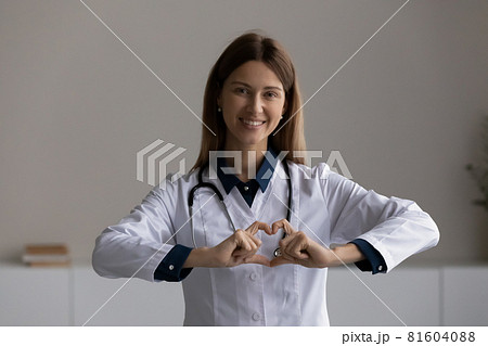 Happy sincere kind female doctor showing love. 81604088