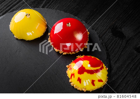 Beautiful cakes covered with glossy red and yellow glaze. Concept design pastry desserts 81604548