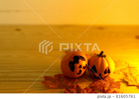 Halloween pumpkins with painted faces on a wooden table. Halloween background. Space for text. copy space. Halloween concept Halloween pumpkins with painted faces on a wooden table. Halloween background. Space for text. copy space. Halloween concept 81605761