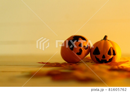 Halloween pumpkins with painted faces on a wooden table. Halloween background. Space for text. copy space. Halloween concept Halloween pumpkins with painted faces on a wooden table. Halloween background. Space for text. copy space. Halloween concept 81605762