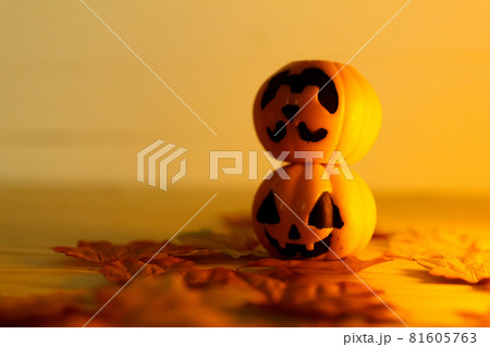 Halloween pumpkins with painted faces on a wooden table. Halloween background. Space for text. copy space. Halloween concept Halloween pumpkins with painted faces on a wooden table. Halloween background. Space for text. copy space. Halloween concept 81605763