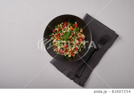 Traditional salad tabbouleh made of bulgur or couscous, poultry meat, parsley. mint, top view 81607254