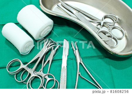 Surgical instruments on the green fabric in the operating room Surgical instruments on the green fabric in the operating room 81608256