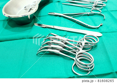 Surgical instruments on the green fabric in the operating room 81608265