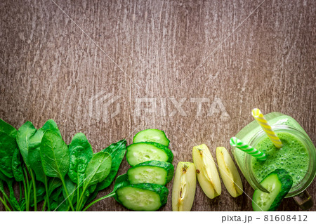Green smoothie with apples, yogurt, spinach, cucumber on wooden background 81608412