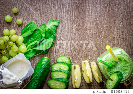 Green smoothie with apples, yogurt, spinach, cucumber on wooden background Green smoothie with apples, yogurt, spinach, cucumber on wooden background 81608415
