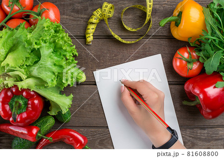 Sport and diet. Vegetables and centimeter. Peppers, tomatoes, salad on rustic background Sport and diet. Vegetables and centimeter. Peppers, tomatoes, salad on rustic background 81608800