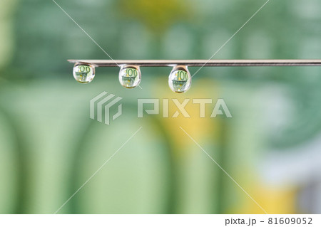 On the needle of the euro. Drops flows from the syringe needle with the reflection of euro. Concept of investment, the cost of drugs and treatment, drug addiction, corruption. 81609052