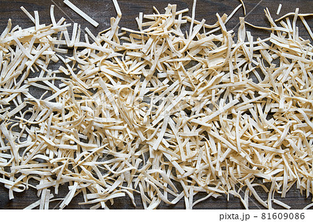 Handmade noodles are dried on a wooden board. Top view Handmade noodles are dried on a wooden board. Top view 81609086