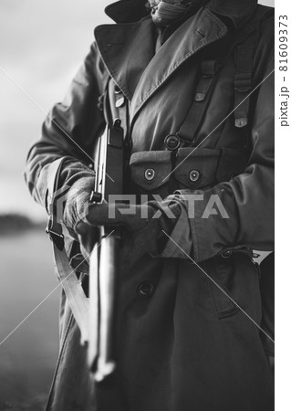 Soldier Of USA Infantry Of World War II Holds Submachine Weapon In Hands. black and white photography 81609373