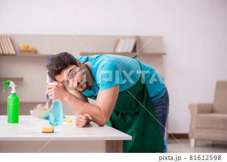 Young male contractor cleaning the house 81612598