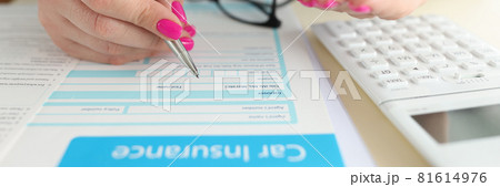 Woman holding toy car in her hands and filling out insurance form closeup Woman holding toy car in her hands and filling out insurance form closeup 81614976