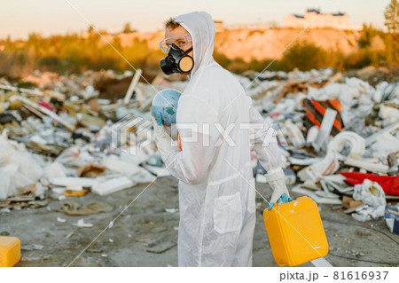 Researcher looking at plastic landfill analyzing environmental pollution level Researcher looking at plastic landfill analyzing environmental pollution level 81616937