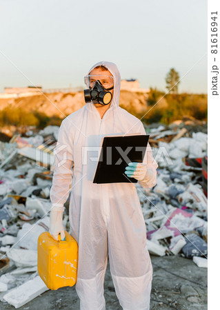 Researcher looking at plastic landfill analyzing environmental pollution level Researcher looking at plastic landfill analyzing environmental pollution level 81616941