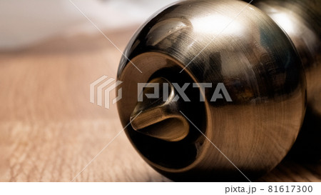 Round doorknob system on a wooden background Round doorknob system on a wooden background 81617300