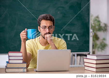 Young male student preparing for exams in the classroom 81619694