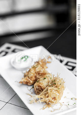 asian fried rice noodle shrimp spring rolls starter on plate 81619801