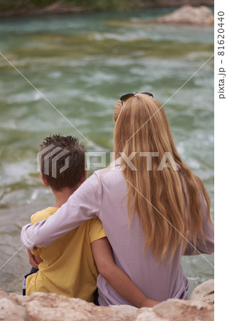 Mother and son watching the mighty river Mother and son watching the mighty river 81620440
