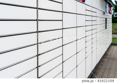 Automated locker. Parcel courier box in woman hands at post delivery automat terminal. Courier Puts Cardboard Package Into Parcel Locker. Automated locker. Parcel courier box in woman hands at post delivery automat terminal. Courier Puts Cardboard Package Into Parcel Locker. 81622109