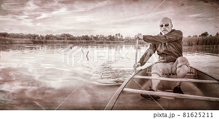 paddling canoe at sunset 81625211