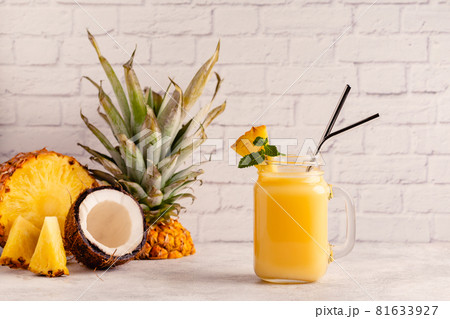 Tropical pineapple smoothie in a mason jar. Tropical pineapple smoothie in a mason jar. 81633927