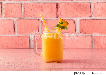 Tropical pineapple smoothie in a mason jar. 81633928