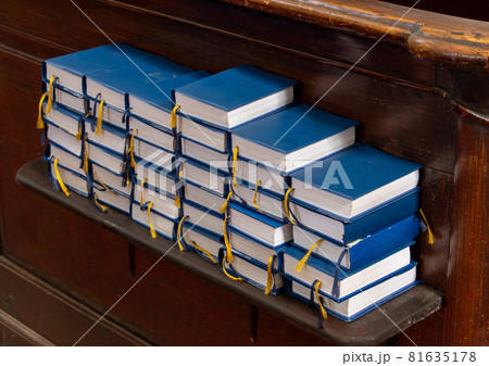 A stacks of books for prayer and religious sing on the shelf in the church A stacks of books for prayer and religious sing on the shelf in the church 81635178
