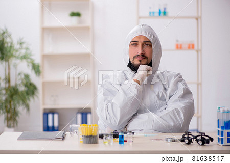 Young male chemist working at the lab during pandemic 81638547
