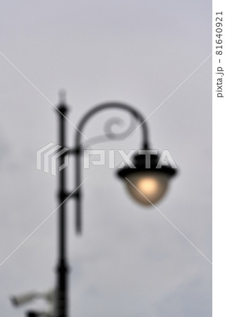 A blurred silhouette of a street lamp, a lantern shining with a voucher 81640921