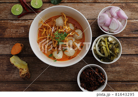 Local northern Thai food Egg noodle curry with meatballs on wood background Local northern Thai food Egg noodle curry with meatballs on wood background 81643295