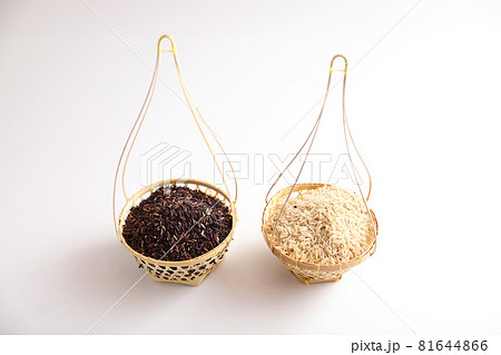Organic raw brown rice and riceberry rice on wood basket in close up 81644866