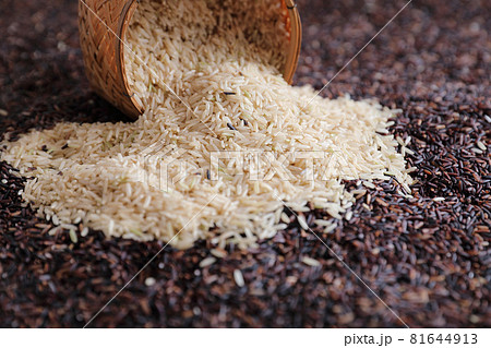 Organic raw brown rice and riceberry rice on wood basket in close up Organic raw brown rice and riceberry rice on wood basket in close up 81644913