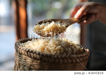 Organic boiled brown rice on Wicker basket in close up Organic boiled brown rice on Wicker basket in close up 81645819