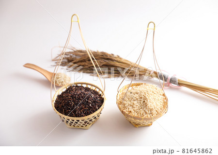 Organic raw brown rice and riceberry rice on wood basket in close up 81645862