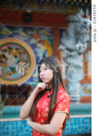 beauty woman wear red cheongsam looking and smile in chinese new year beauty woman wear red cheongsam looking and smile in chinese new year 81646259