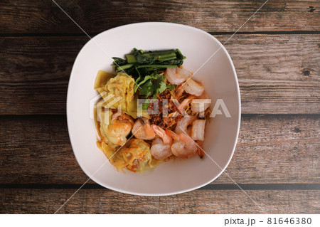 Shrimp dumpling with shrimp on wood background Shrimp dumpling with shrimp on wood background 81646380