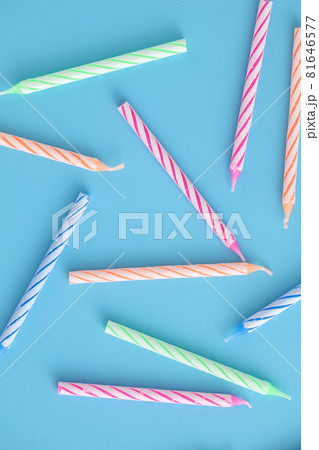Colorful candles isolated in blue background Colorful candles isolated in blue background 81646577
